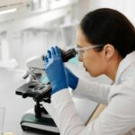 A focused scientist using a microscope in a modern laboratory, conducting important research.